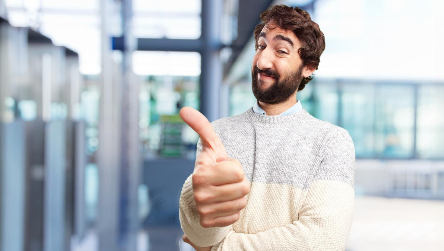 A man smiling with his thumb up