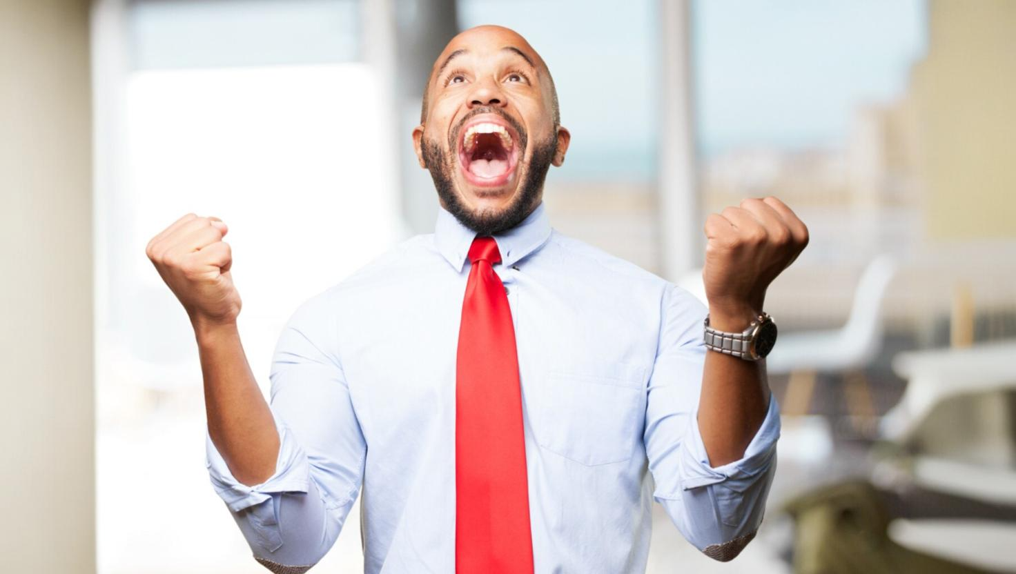 A man smiling with his fists up celebrating the benefits of an omnichannel solution
