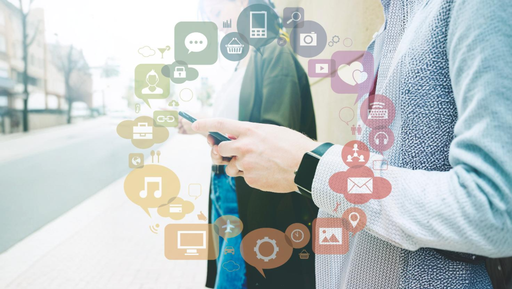 Hands holding a phone with icon s floating on top conveying an Omnichannel Solution