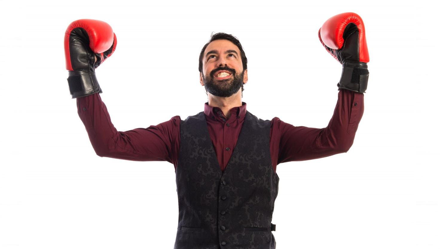 Man celebrating with boxing gloves raised winning at customer experience with the Contact Hub omnichannel solution.