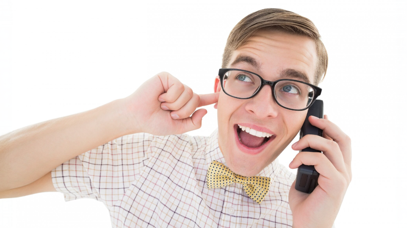 Nerdy looking man in bowtie and glasses on phone call. Conveys choosing Magic Apple as cloud phone provider is a smart call.